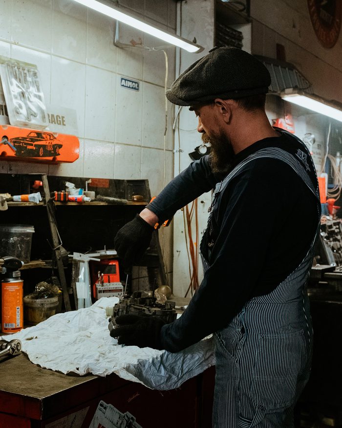 Line of credit working capital: a mechanic working an engine part at his bench
